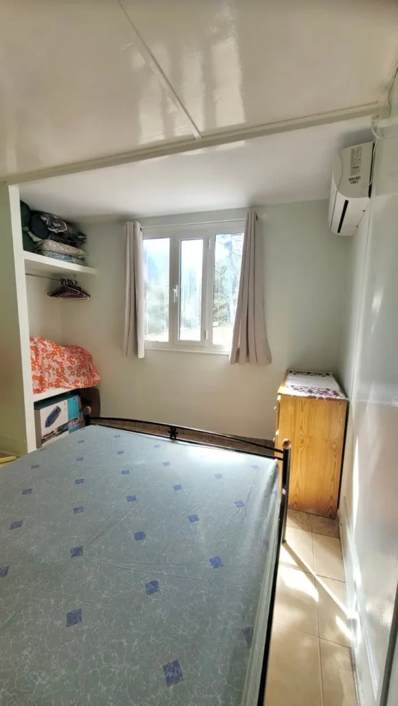 Cozy bedroom with double bed, air conditioning, and natural light at Sylvia House Telendos