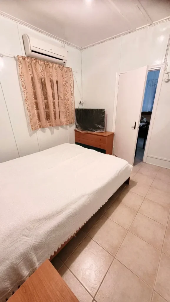 Double bedroom with air conditioning and television at Sylvia House accommodation in Telendos