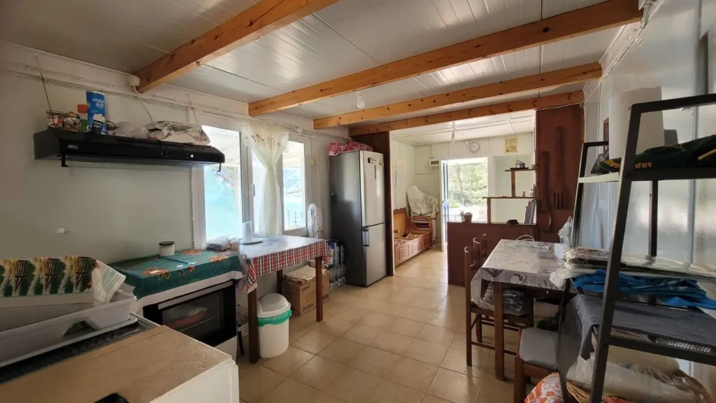 Open-plan kitchen, dining, and living area at Sylvia House accommodation on Telendos Island