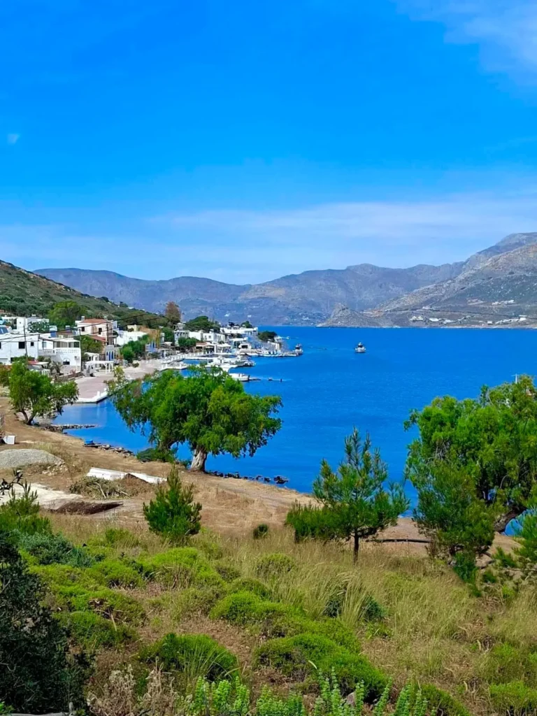 Scenic bay view of Telendos Island with traditional waterfront houses and deep blue Aegean waters