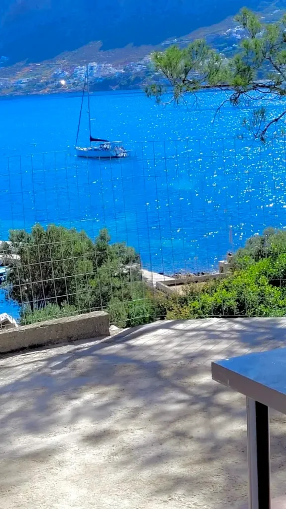 Sea view terrace overlooking the Aegean Sea with sailboat near Sylvia House Telendos