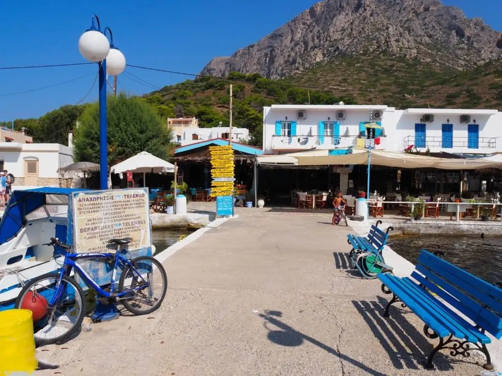 Waterfront promenade with cafes and mountain views at Telendos Island near Sylvia House