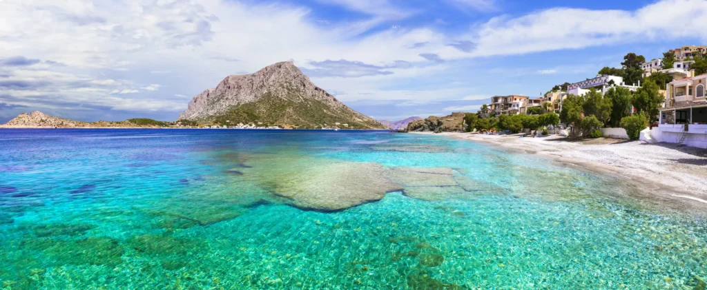 Crystal clear turquoise waters and beach view of Telendos Island in the Aegean Sea